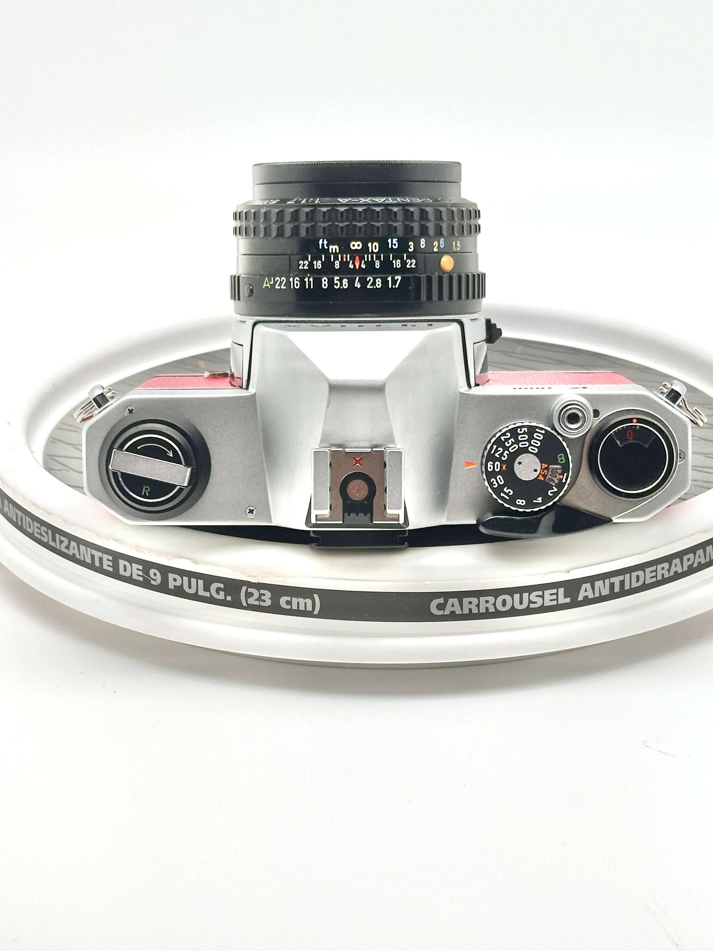 Japanese Asahi Pentax K1000 red 35mm film camera with 50mm lens top view on display.
