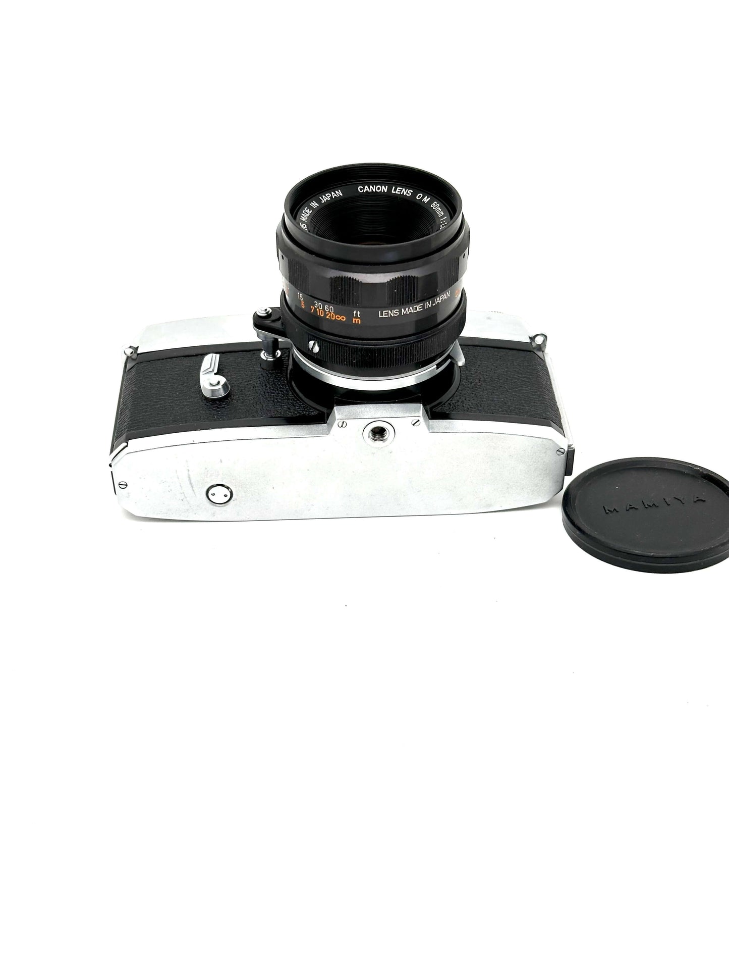 Mamiya Prismat NP 35mm vintage film camera with Canon 50mm f1.9 lens, showcasing a shiny silver and black body.