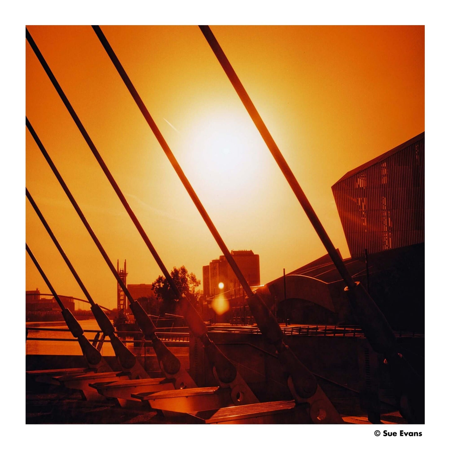 Dramatic sunset glow with red tones over city skyline, showcasing creative use of light and color.