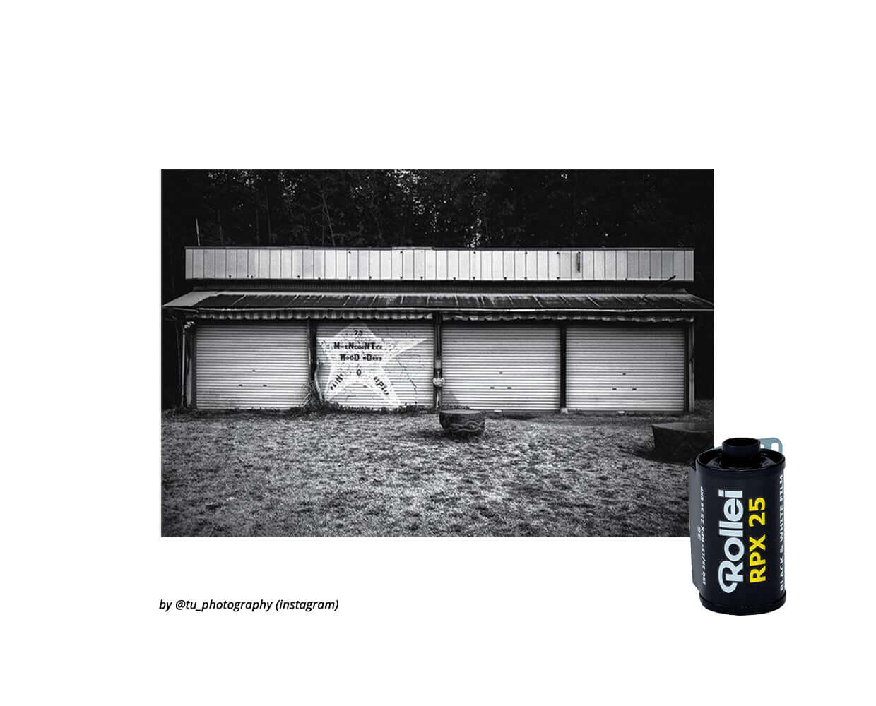 Rollei RPX25 black and white film canister beside a rustic garage in monochrome photography.