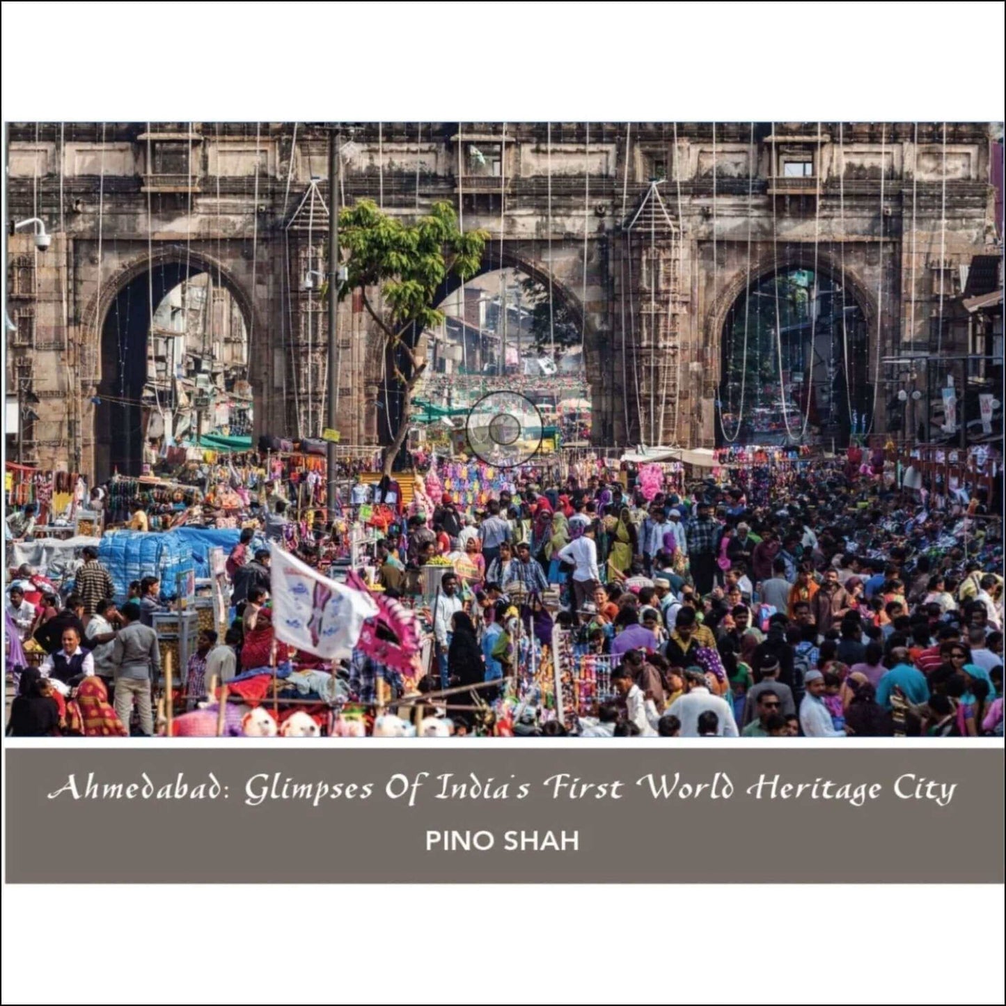 Crowded market scene in Ahmedabad, showcasing India's first World Heritage City by Pino Shah.