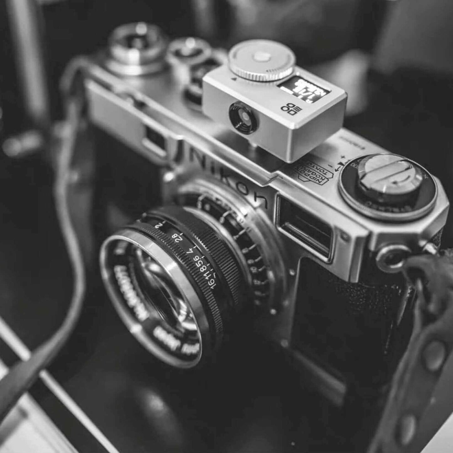 Close-up of a camera with a DOOMO Meter S light meter attached for precise exposure measurement.