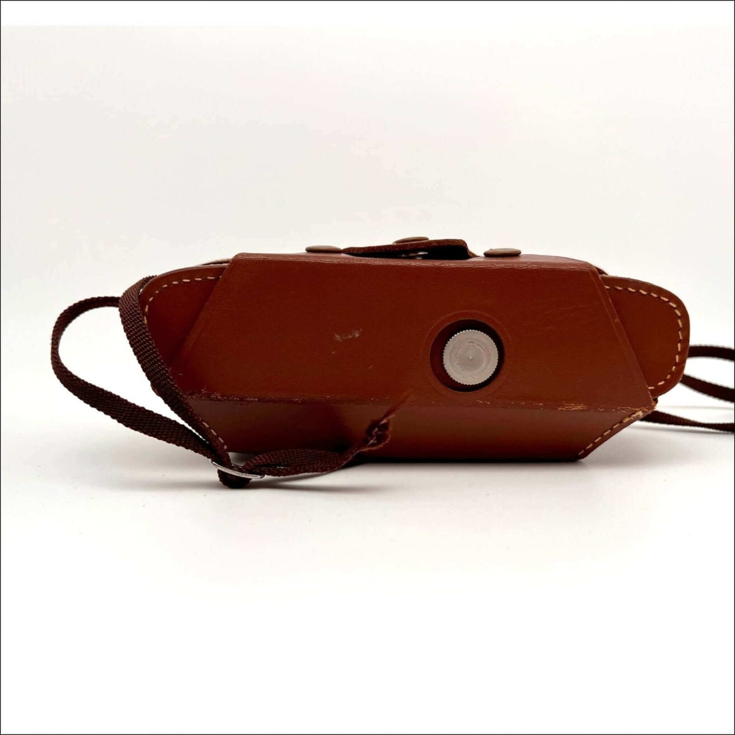 Close-up of the bottom view of a Kodak vintage Stereo 35mm film camera with original case, showcasing its design details.