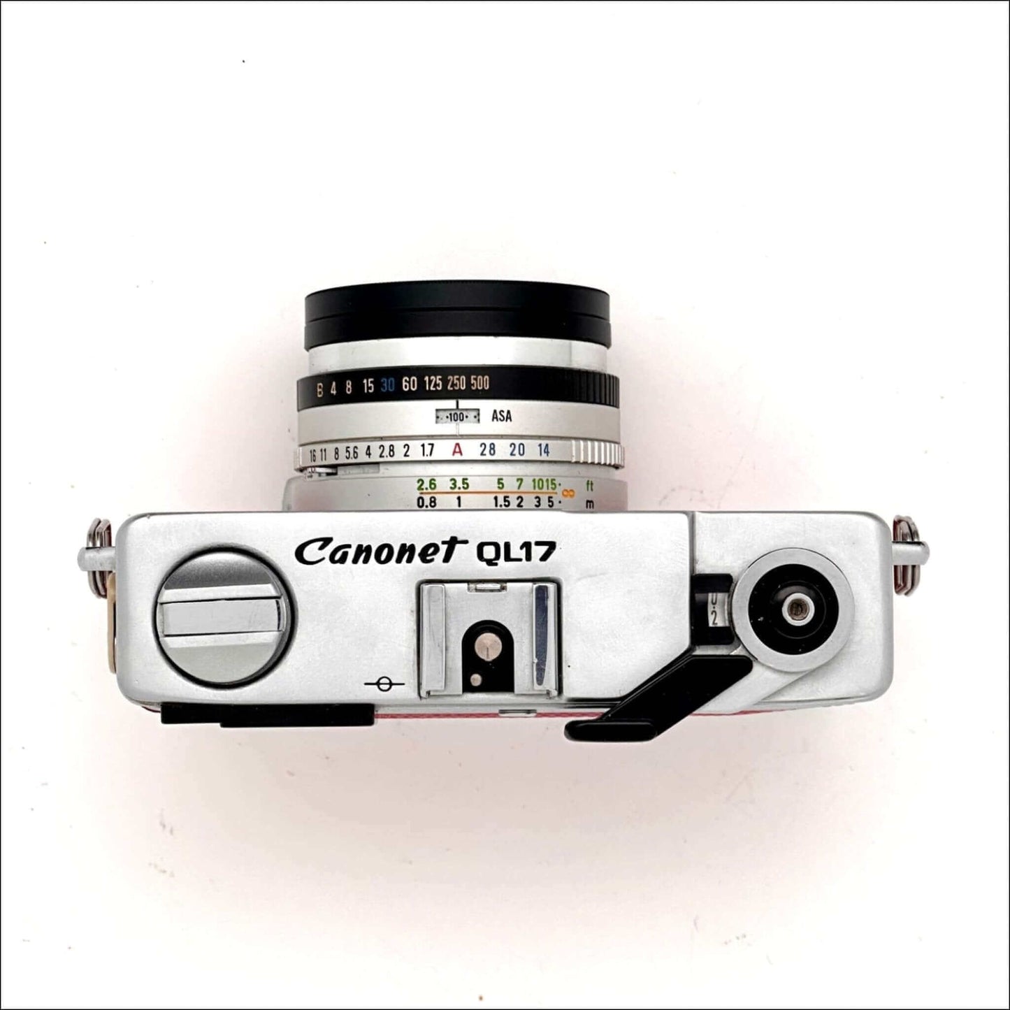 Top view of a Canon Canonet QL17 GIII used 35mm rangefinder camera in hot pink color, featuring a classic design.
