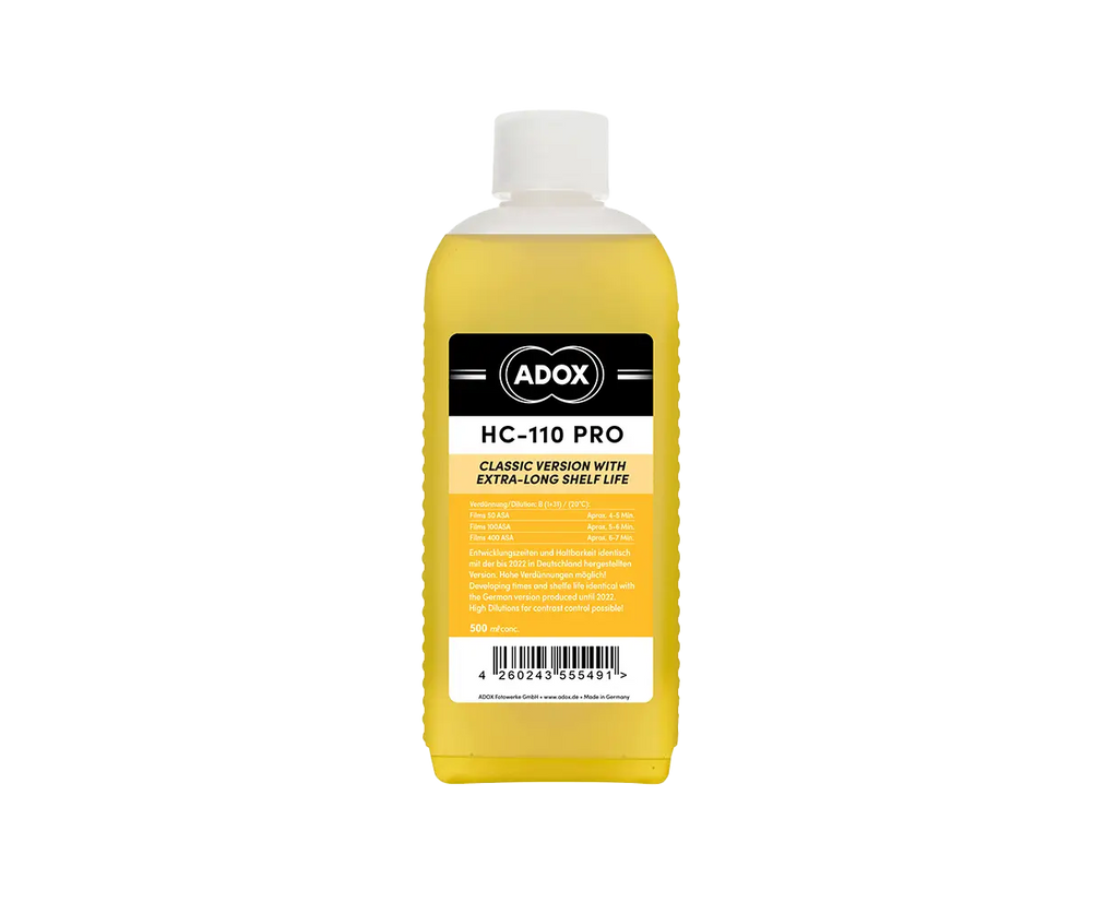 A yellow liquid-filled bottle with a white cap and black-and-yellow label, branded as ’adox hc-110 pro.’