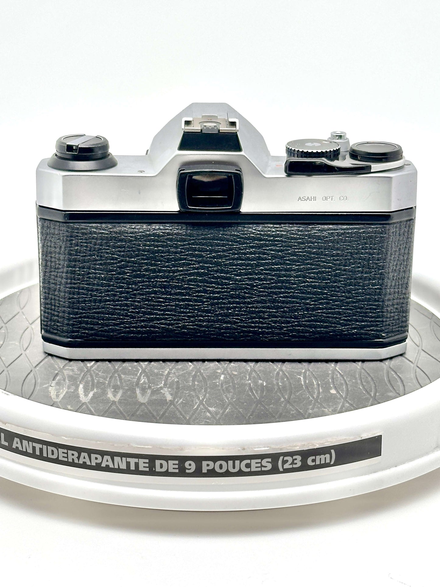Back view of used Japanese Asahi Pentax K1000 black 35mm film camera showing textured grip and controls.