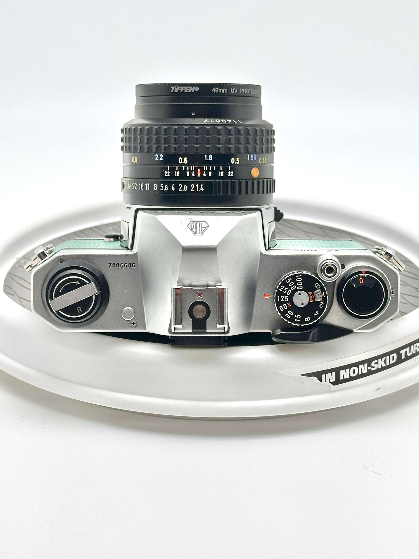 Japanese Asahi Pentax K1000 teal 35mm film camera with 50mm f1.4 lens, vintage photography gear.