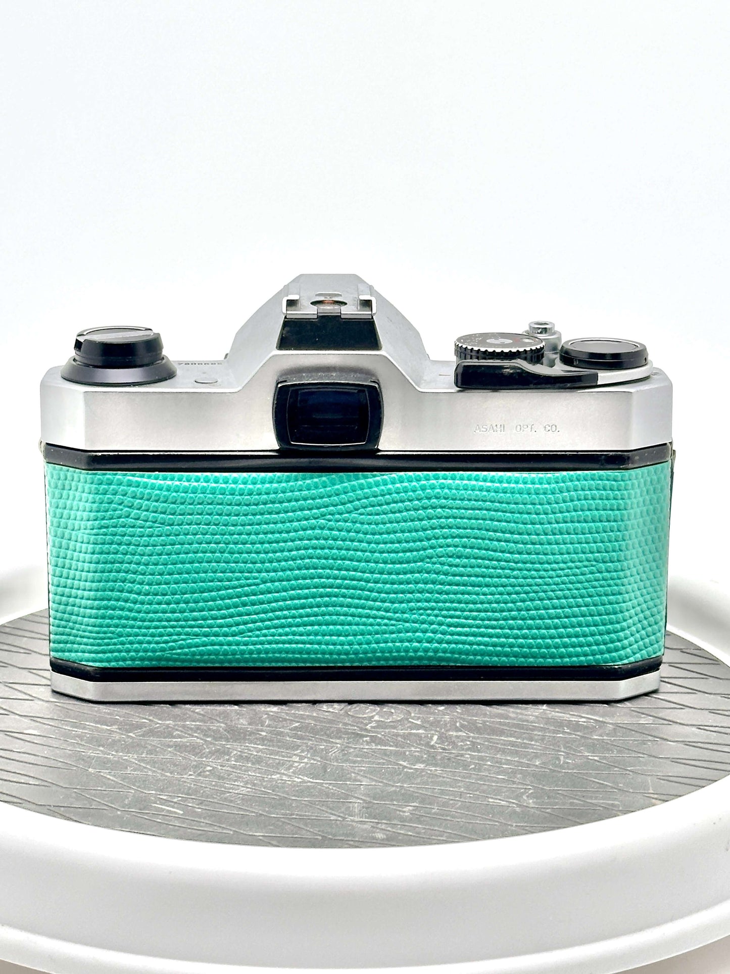 Back view of Japanese Asahi Pentax K1000 used 35mm film camera in teal with textured grip.