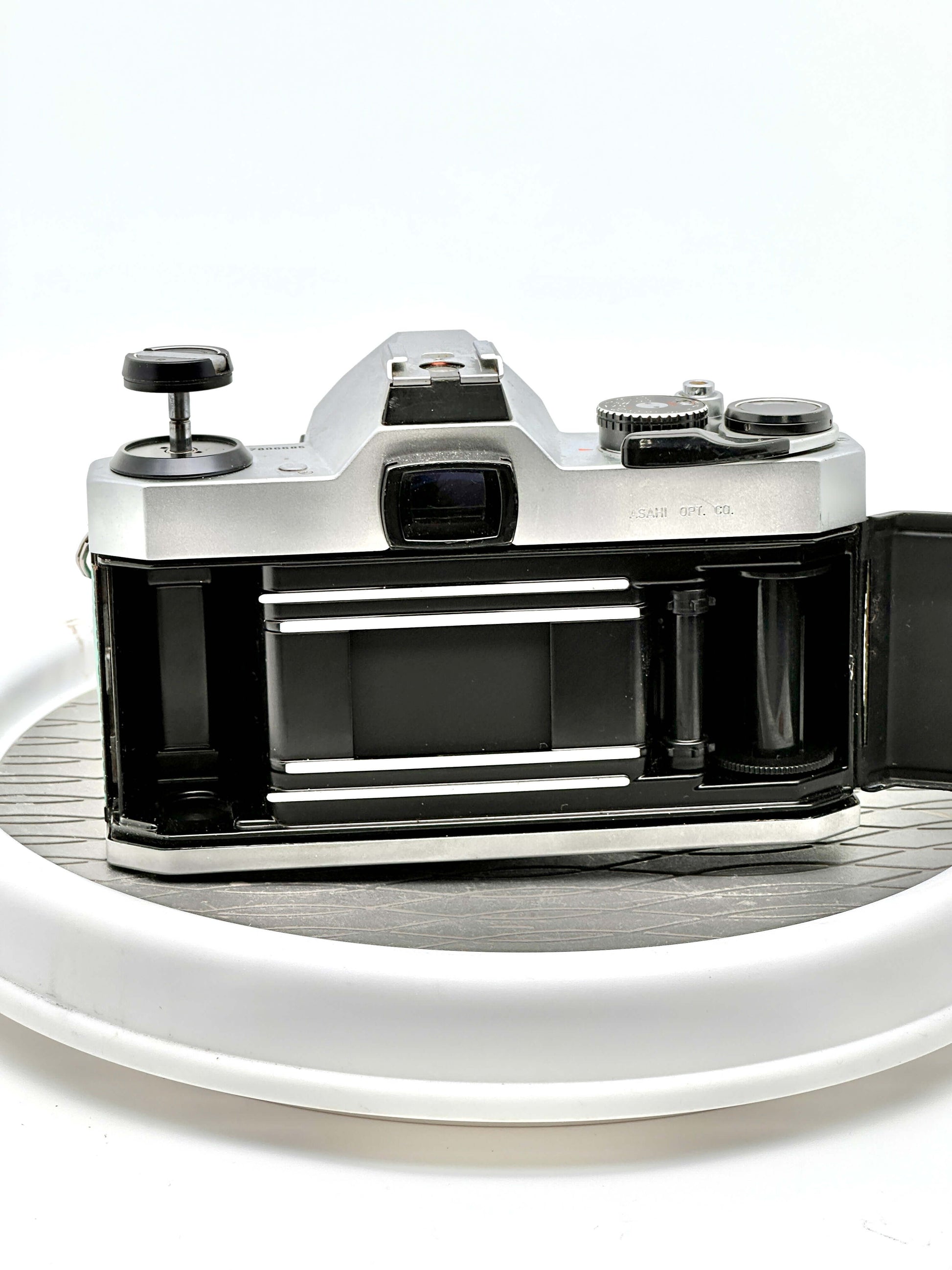 Back view of a Japanese Asahi Pentax K1000 35mm film camera with lens removed, showcasing its sturdy construction.