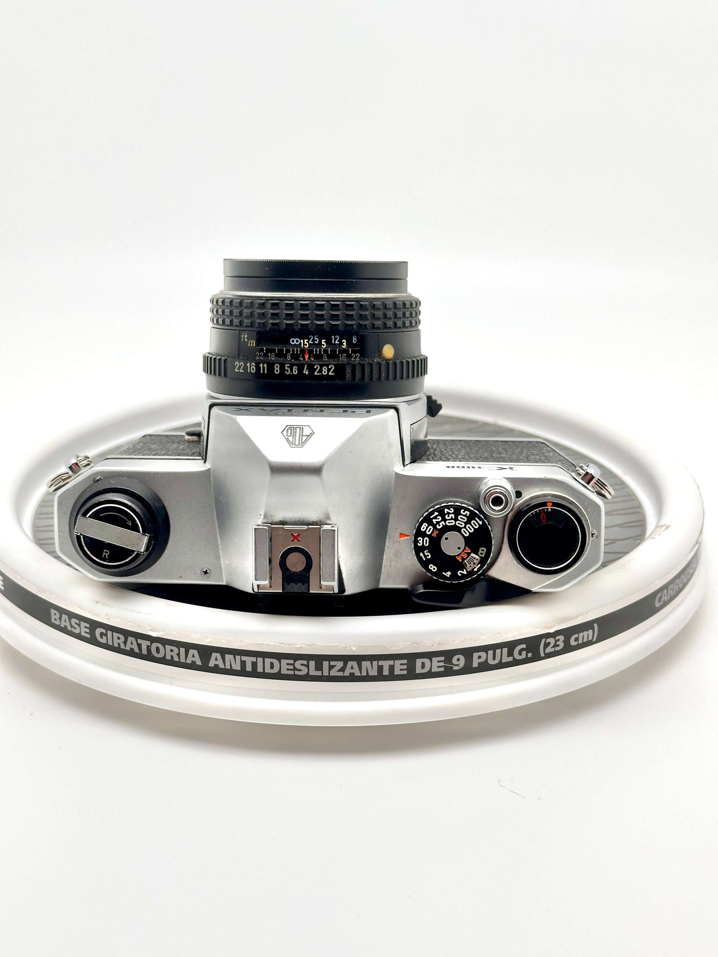 Pentax K1000 black 35mm film camera top view with 50mm f2 lens, showcasing vintage design and classic controls.