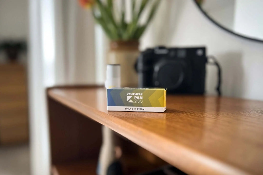 A sleek rectangular box of kentmere pan 200 black & white film, featuring a gradient design with blue and yellow hues on its packaging.