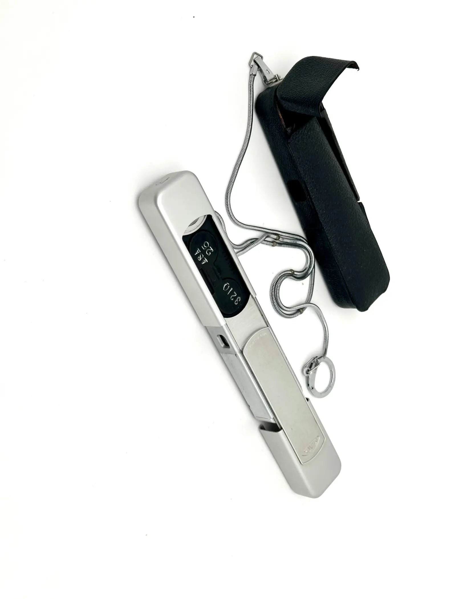 Silver digital thermometer with a sleek, rectangular design and black display screen.