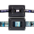 Black film scanner with two rectangular scanning units, each displaying a strip of photographic negatives.