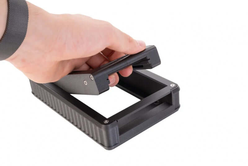 Hand holding the Negative Supply Simple 35 and 120 Film Scanning System for film digitization.