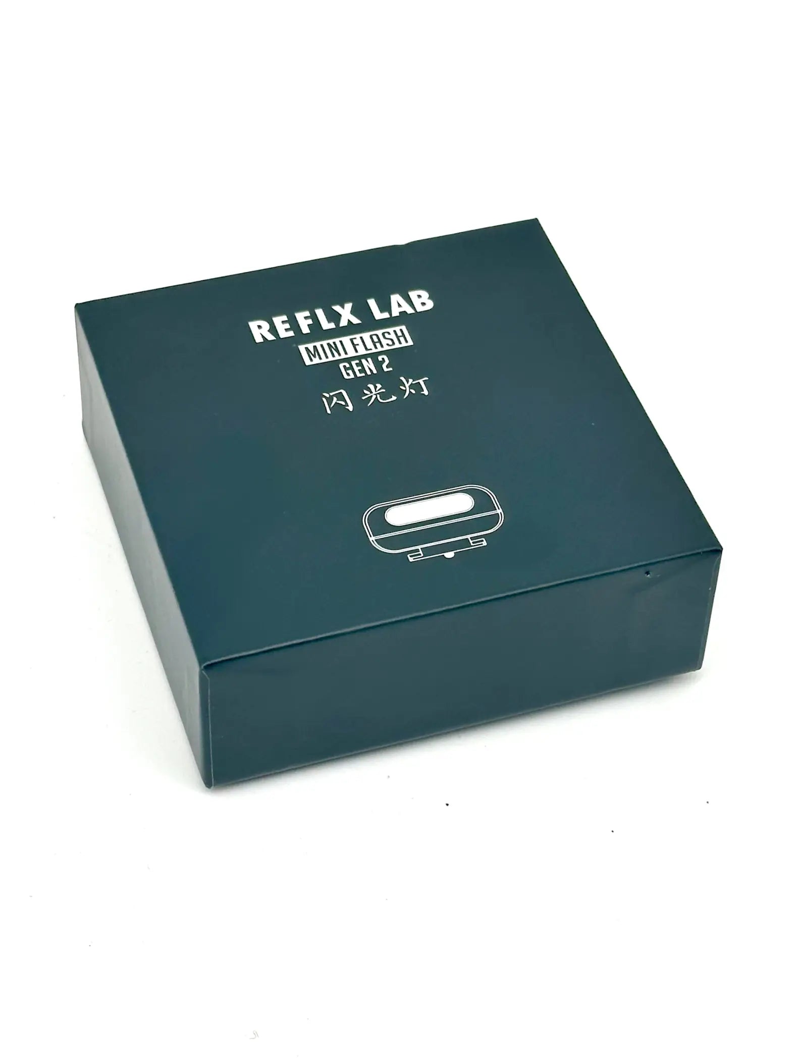 Dark teal rectangular box for the reflx lab mini flash gen 2 flash light.