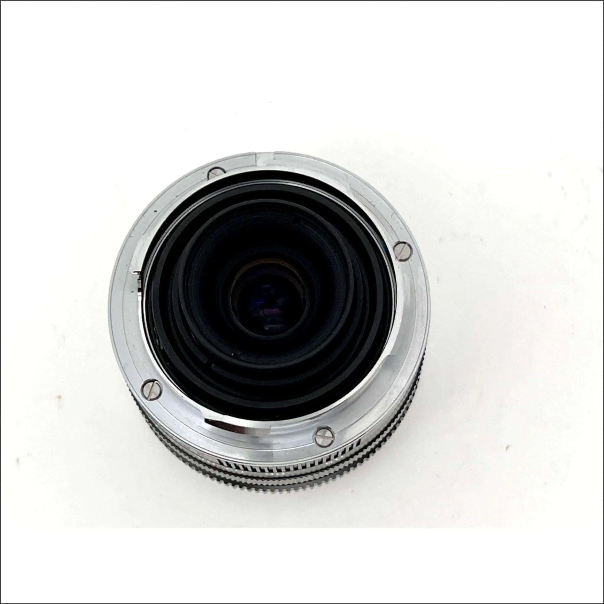 Silver-bodied camera lens with a textured focus ring and black glass elements.