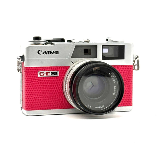 Used Canon Canonet QL 17 GIII 35mm rangefinder camera in vibrant hot pink with silver detailing.