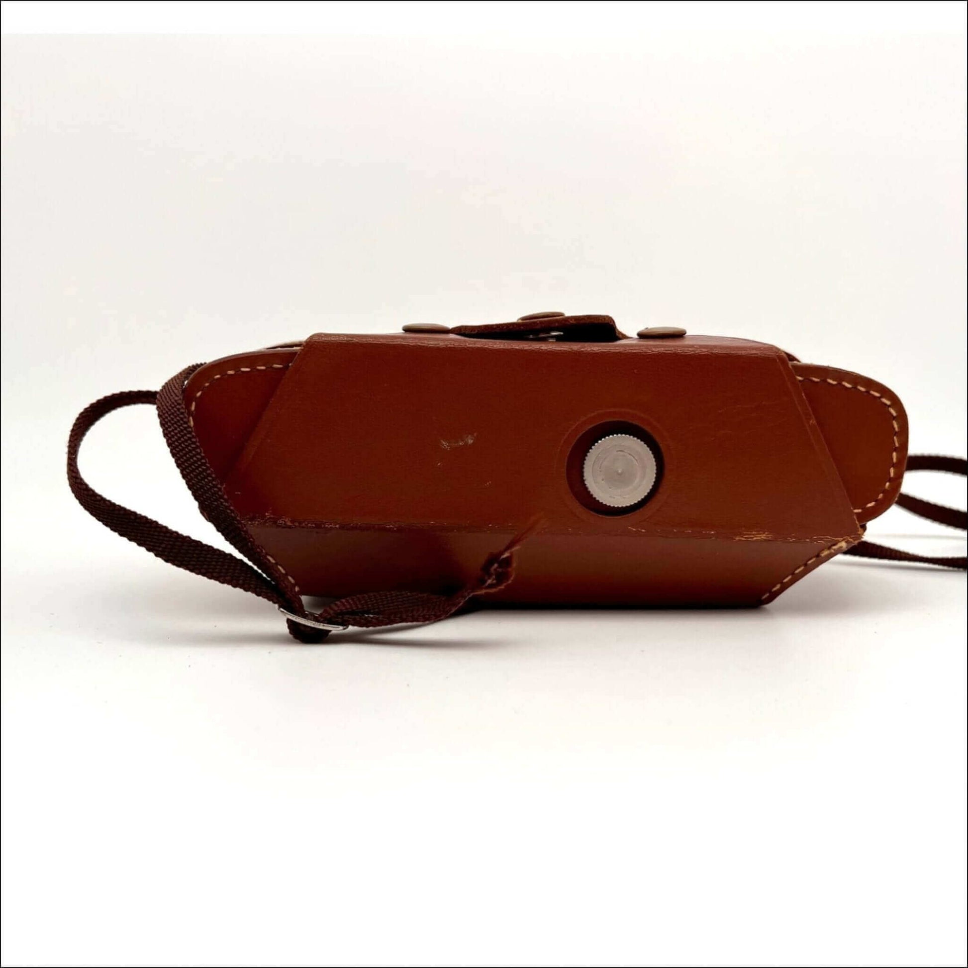 Close-up of the bottom view of a Kodak vintage Stereo 35mm film camera with original case, showcasing its design details.