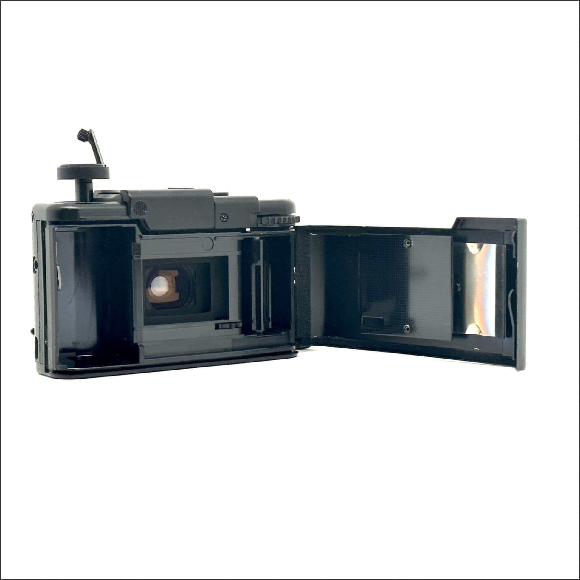 Olympus XA used 35mm vintage film camera showing open chamber and lens area, in fine working condition.