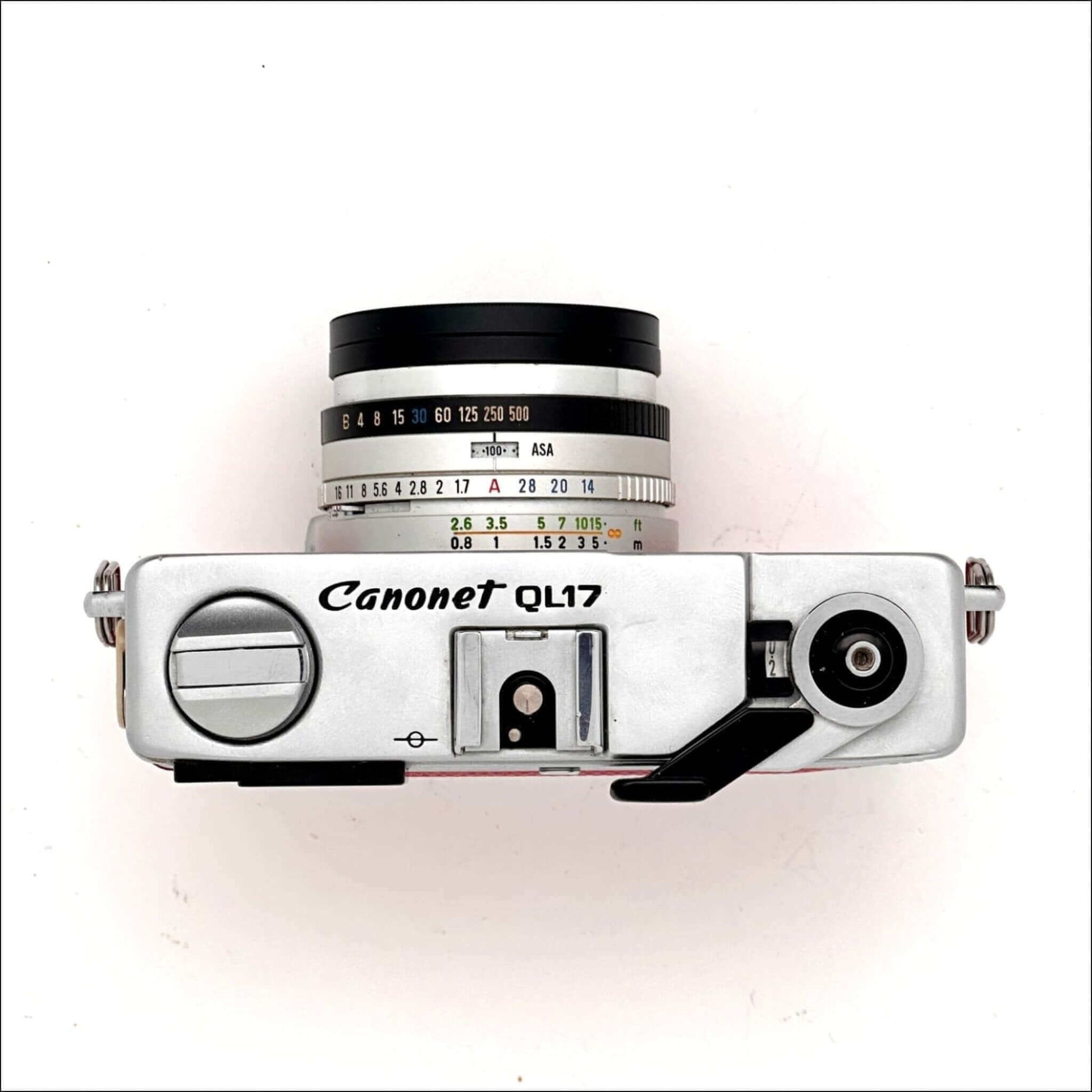 Top view of a Canon Canonet QL17 GIII used 35mm rangefinder camera in hot pink color, featuring a classic design.